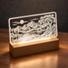 LED Illuminated Acrylic Engraving with Wooden Base Illuminated engraved acrylic landscape panel with warm LED lighting and a wooden base.